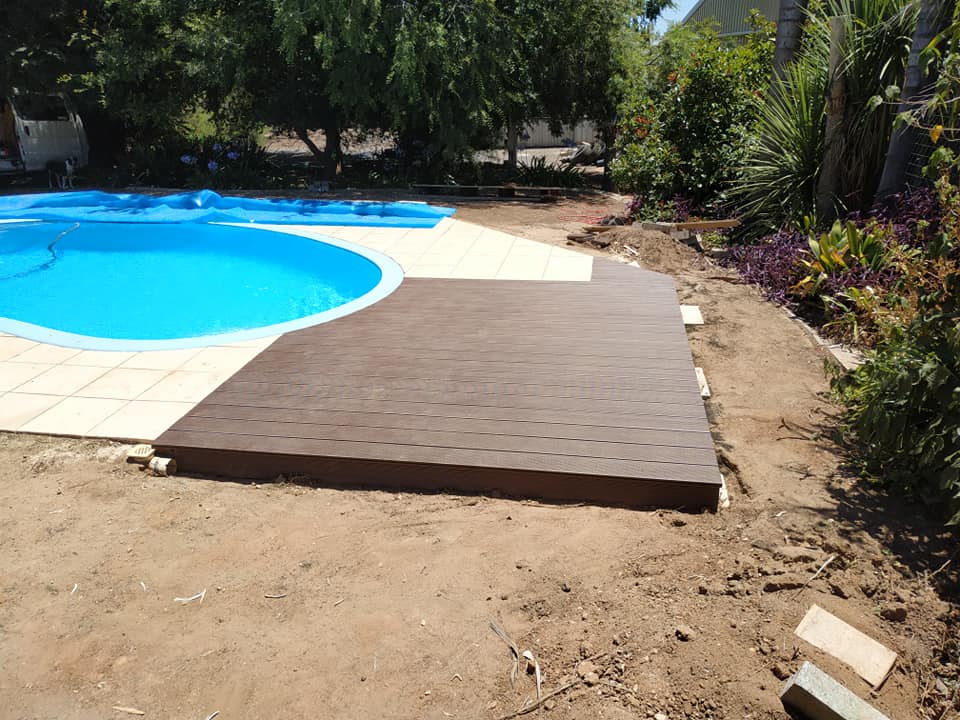 Elevate your poolside with a custom composite deck, blending durability, aesthetics, and low maintenance for stylish relaxation and entertainment.